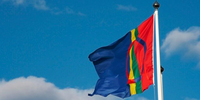 samiska flaggan hissad mot blå himmel